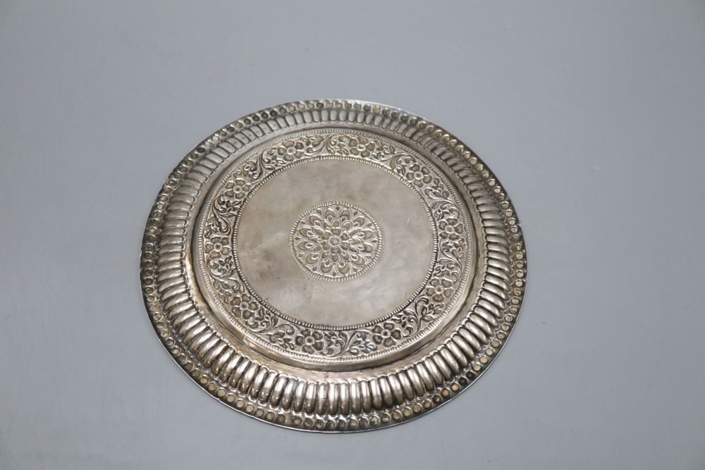 An Indian white metal salver, with floral decoration inscribed from His Highness Maharana of Dharampur, diameter 21.5cm